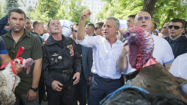 Vladimir Plahotniuc, the leader of the Moldova's Democratic party, and the country's de facto leader, clenches his fist gesturing next to interim president Pavel Filip, right.