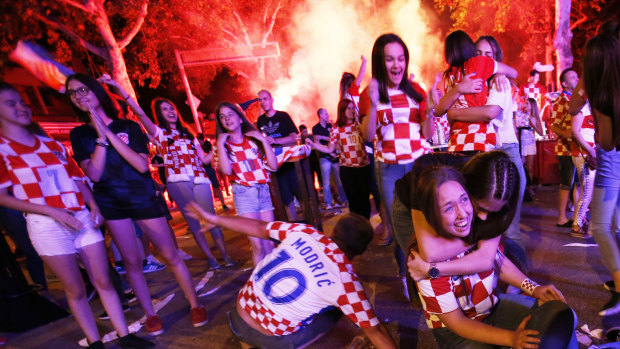 Croatian supporters celebrate as their team beat Russia.