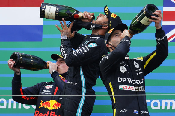 Daniel Ricciardo (right) celebrates on the podium.