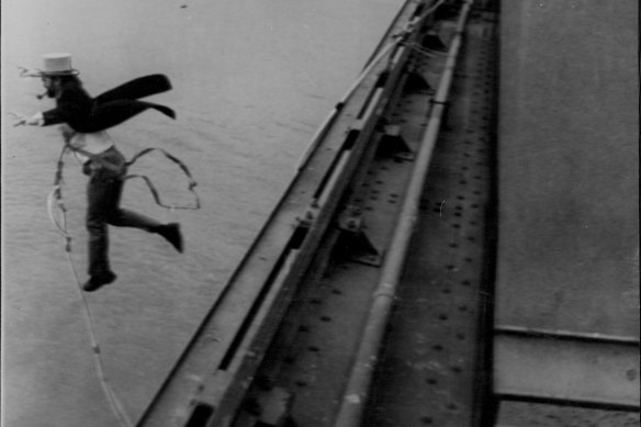 Pipe clenched between his teeth, top-hatted David Kirke leaps off a ledge in 1979.