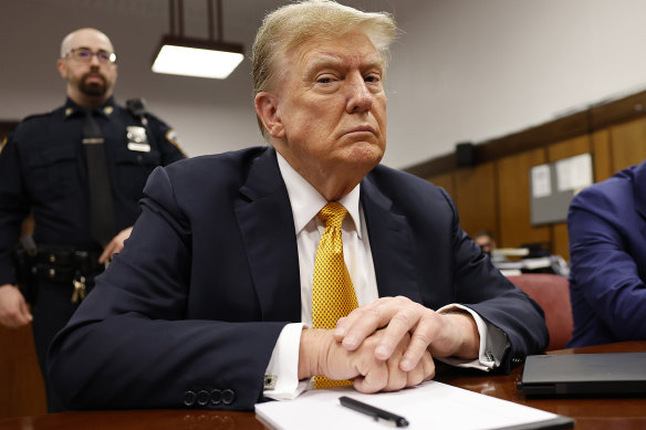 Former president Donald Trump sits in the courtroom for his trial at the Manhattan criminal court during his trial.