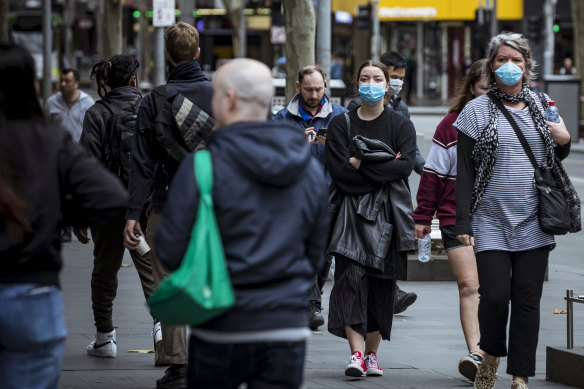 Melburnians wearing face masks in the city on Sunday.