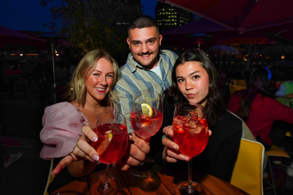 Ruby Keeble, Daniel Moshopoulos and Elena Boyce enjoy drinks at Arbory Afloat on the Yarra River.