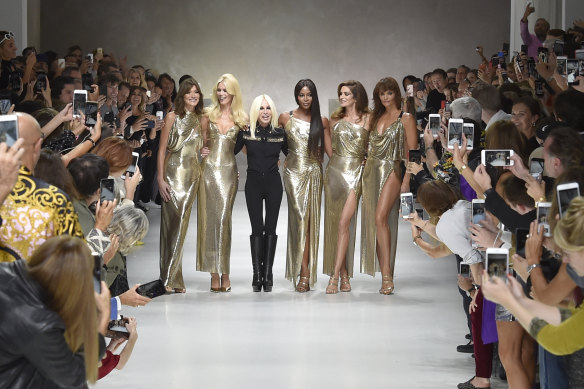 Donatella Versace with supermodels (left to right), Carla Bruni, Claudia Schiffer, Naomi Campbell, Cindy Crawford, Helena Christensen, walk the runway at the Versace Spring Summer 2018 fashion show during Milan Fashion Week.