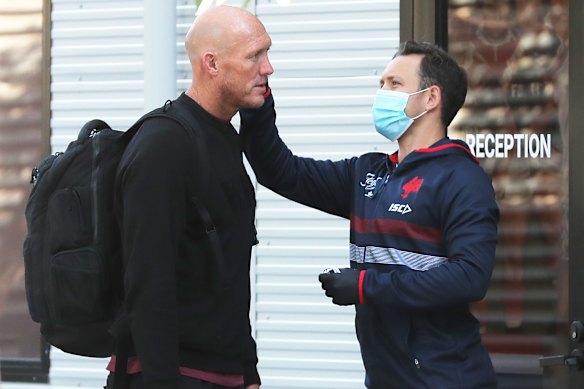 Roosters assistant Craig Fitzgibbon has his temperature checked after arriving at the club's Moore Park headquarters on Monday.