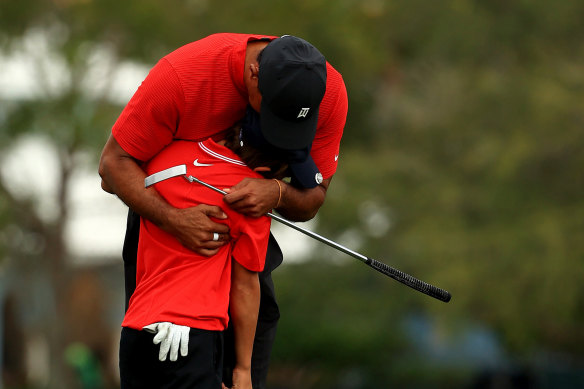 Tiger Woods hugs his son Charlie after their final round.