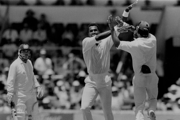 David Boon watches Ian Bishop celebrate one of many wickets in 1993.