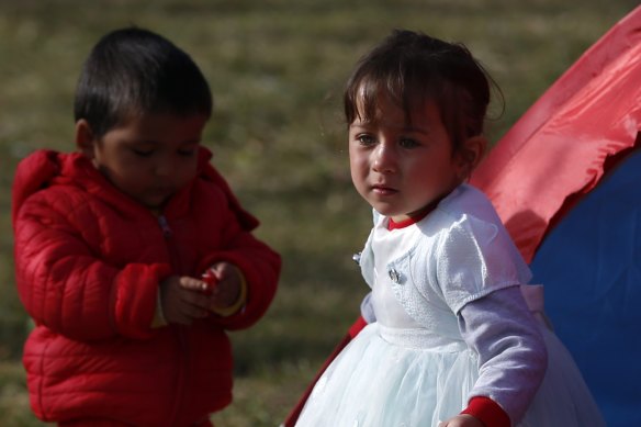 Children stand outside a tent in a field in Edirne, near the Turkish-Greek border on Sunday. Germany is considering taking in young children to help Turkey manage the increasing volumes of migrants and refugees.