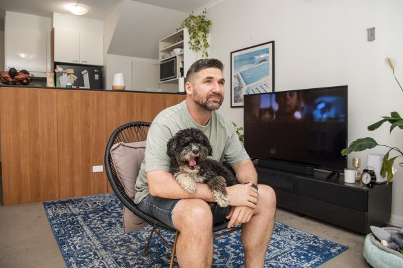 Michael Jermyn has an outdoor chair in his living room as he waits for the delivery of a sofa.