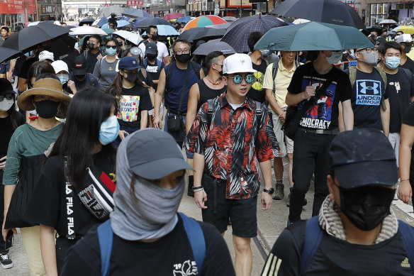 Protesters including ordinary Hong Kongers have marched in defiance of the mask ban.