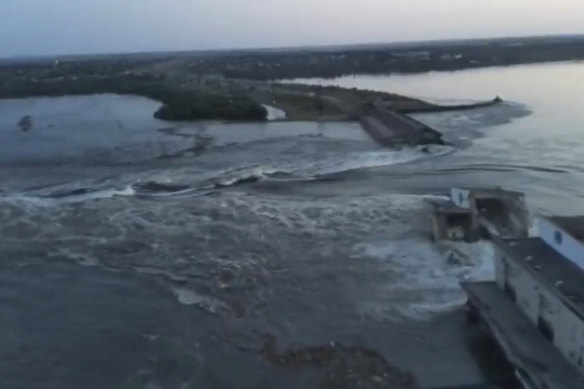 In this image taken from video released by the Ukrainian Presidential Office, water runs through a breakthrough in the Kakhovka dam in Kakhovka, Ukraine.