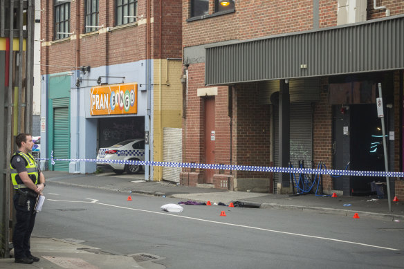 Police officers at the scene on the morning after the fatal shooting.