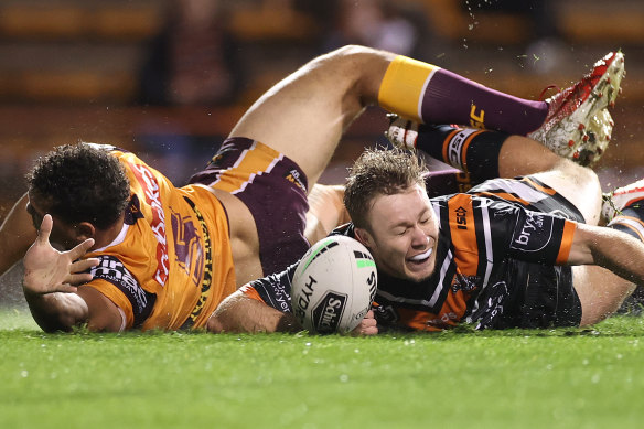 Tigers five-eighth Billy Walters wins the race to the ball to score a second-half try on Friday night.