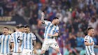 Lionel Messi celebrates during the penalty shootout of the 2022 FIFA World Cup final.