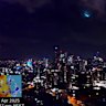 The bright flash of a meteor falling to earth above the Brisbane city skyline on the evening of April 21, 2025.