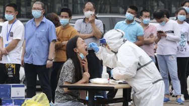 Workers line up for a test at a large factory in Wuhan.