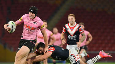 Matt Burton beats the tackle of James Tedesco at Suncorp Stadium.