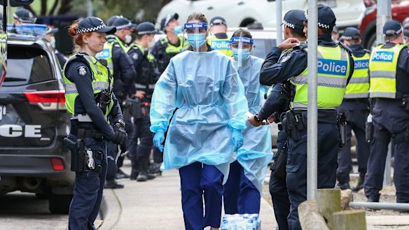 Police and health workers outside the Flemington public housing flats.