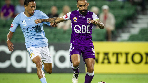 Giving chase: Melbourne City's Kearyn Baccus pressures Perth's Diego Castro.