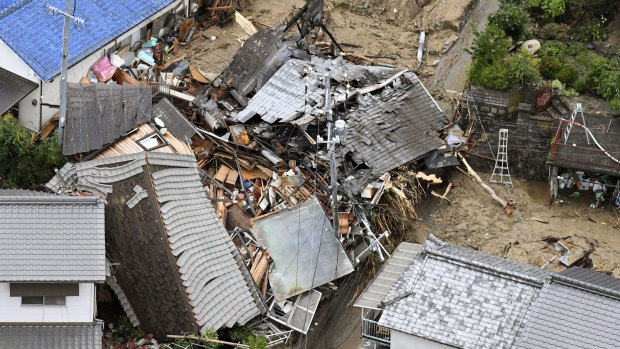 Residential buildings are damaged by a landslide in Sakacho, Hiroshima.