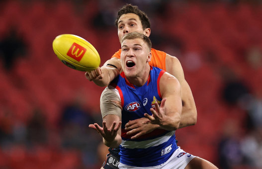 Robbie McComb and Josh Kelly battle for the ball.