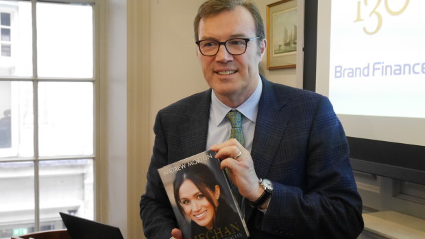 Biographer Andrew Morton with a copy of his book about Meghan, now the Duchess of Cornwall.