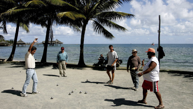Locals play petanque on the beach in Noumea, the capital of New Caledonia.