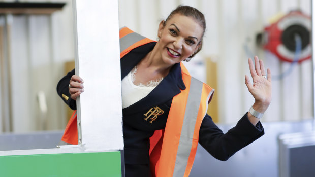 Labor MP Anne Aly poses for photos with a bus during the 2019 Federal Election.