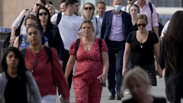 People walk over London Bridge on “Freedom Day”, marking the end of coronavirus restrictions.