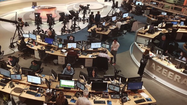 Al-Jazeera staff work at their TV station in Doha, Qatar.