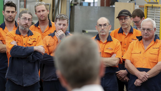 Opposition Leader Bill Shorten (foreground) meets with workers at the Volgren bus facility in Perth, WA, on Wednesday.