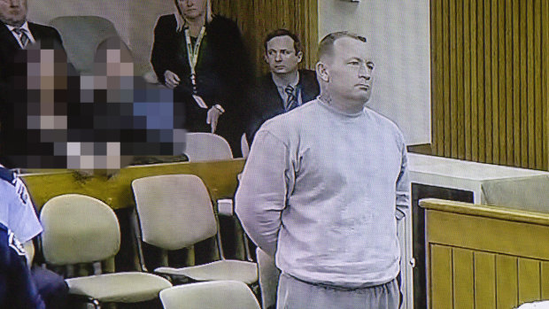 Graham Dillon listens to Justice John Burns as he is handed a sentence of 41 years and one month. Photo was taken from a television screen broadcasting the sentencing live for media within the Supreme Court.