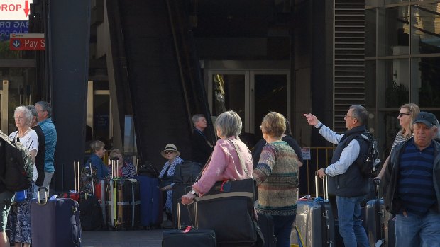 Passengers depart the Ruby Princess cruise ship in Sydney. The ship has now been the source of over 620 COVID-19 cases and 11 deaths.