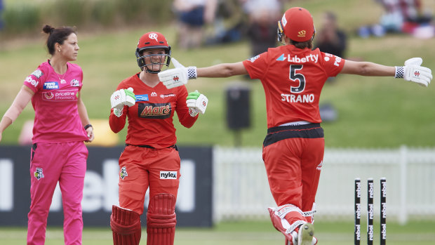 Winning ways: Player of the Match Courtney Webb (centre) celebrates with Molly Strano after sealing victory for the Renegades.