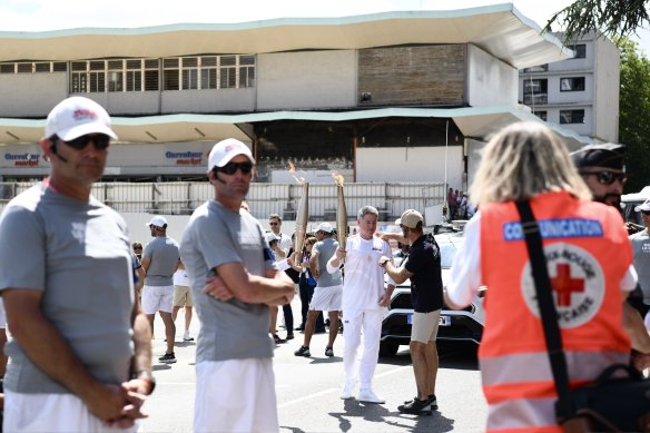 Nine chief executive Mike Sneesby carries the Olympic torch.