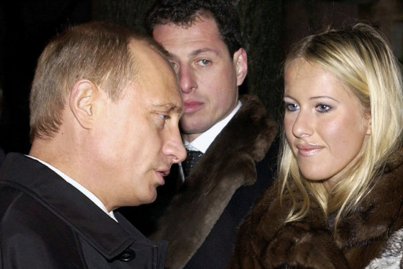 Russian President Vladimir Putin, left, speaks to Ksenia Sobchak, daughter of former St Petersburg mayor Anatoly Sobchak in 2003.