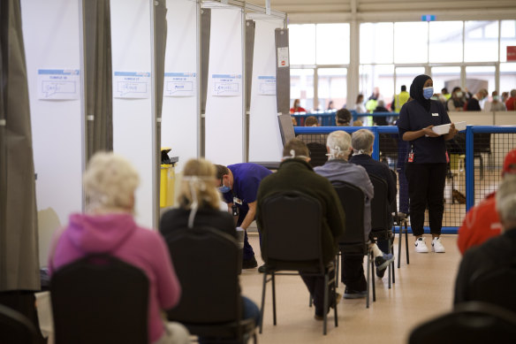 Victorians wait for a jab at the Melbourne Showground vaccination hub on Wednesday. 