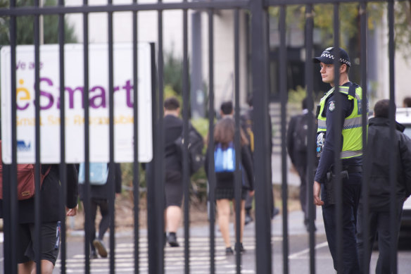 A police officer at the gates of Victoria University Secondary College in St Albans, where Solomone Taufeulungaki was a student, on Wednesday morning.