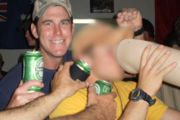 Ben Roberts-Smith (left) with a former colleague drinking from the prosthetic leg of a dead Afghan man in 2012.