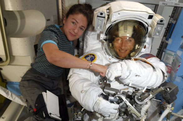 Christina Koch and Jessica Meir pose ahead of their spacewalk. They had to wait for suits that fitted them. 