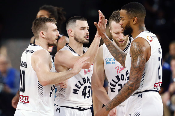 Coach wants more: Melbourne United teammates celebrate following a win over the Breakers. 
