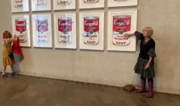 Protesters glue themselves to Warhol Campbell’s Soup Cans at the National Gallery of Australia. 