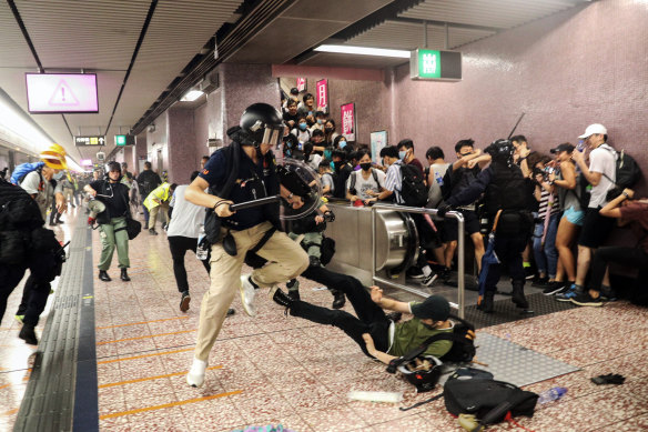 Police attempt to arrest protesters at Prince Edward Station in Hong Kong.