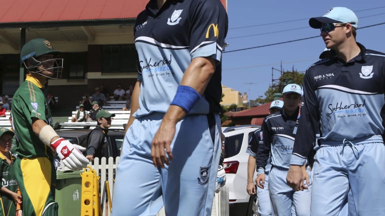 Back in the suburbs: David Warner comes out to open the batting for Randwick Petersham with Steve Smith fielding for Sutherland.