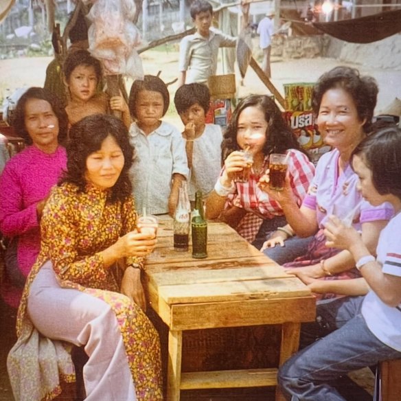 In her aunt’s makeshift cafe in a Thai refugee camp in 1977 (Chu fourth from left, her aunt Yen and mum at left.)