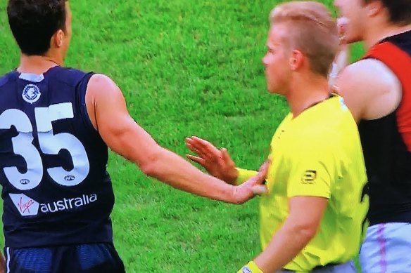 Carlton's Ed Curnow makes physical contact with an umpire.