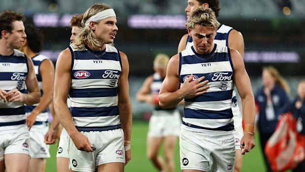 Tanner Bruhn (right) leaves the ground with his teammates aftee their win over the Crows.