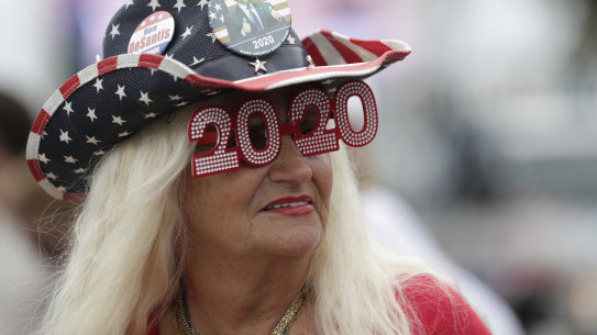 A supporter is seen as she waits to see the motorcade carrying US President Donald Trump pass by on his way to Mar-a-Largo.