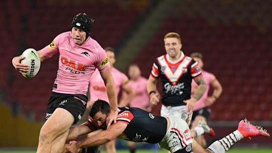 Matt Burton beats the tackle of James Tedesco at Suncorp Stadium.