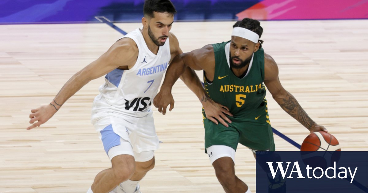 The winner of the match, Patty Mills, is waving the flag ...